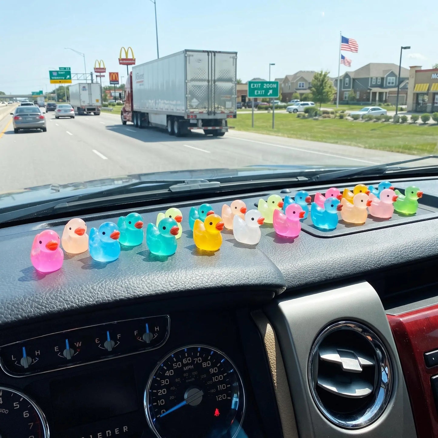 Colorful mini ducks decorating a vehicle dashboard