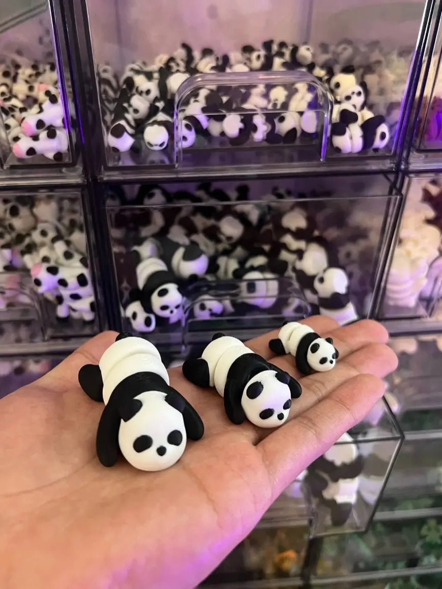 Pocket-sized articulated panda figurines shown in hand